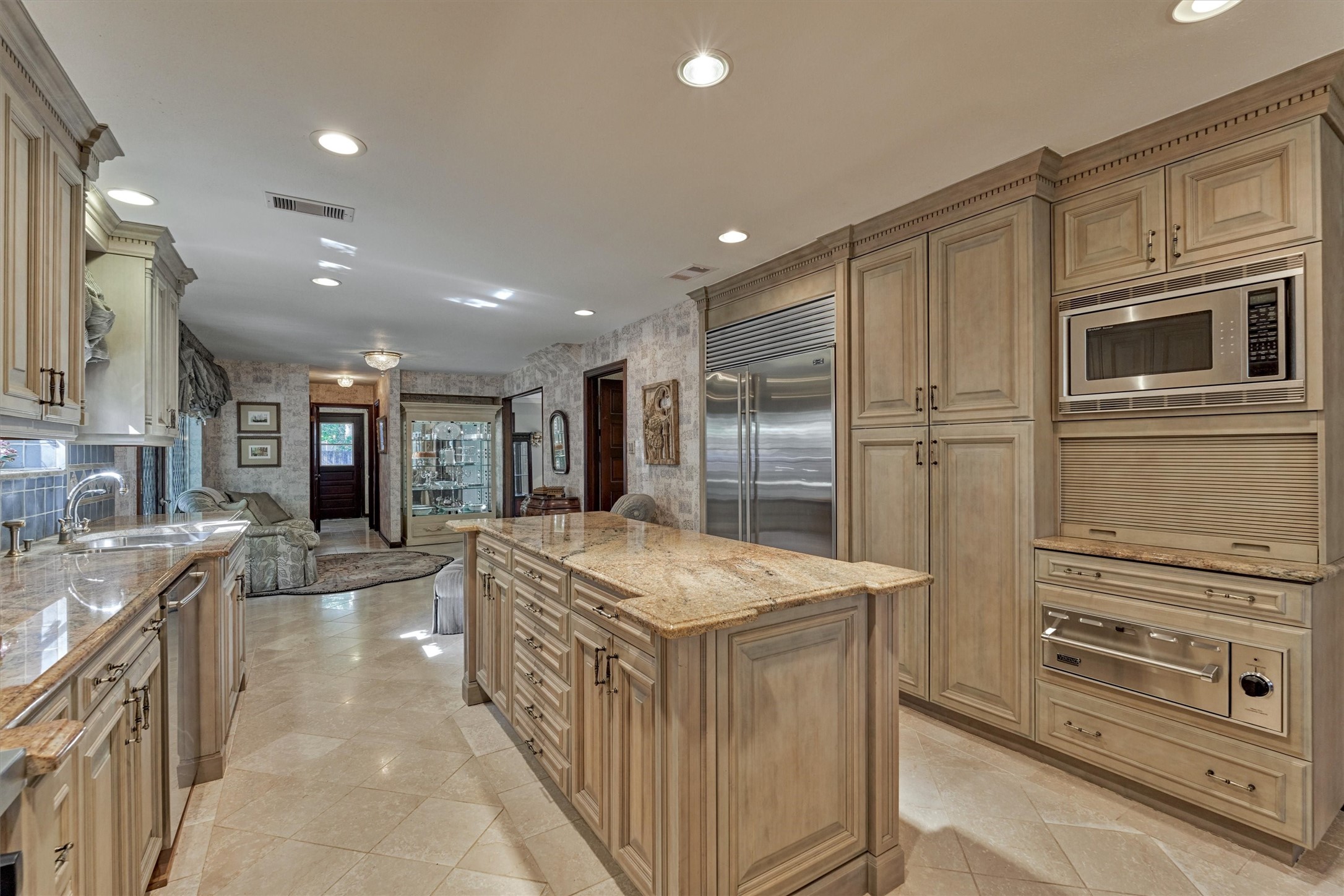 6106 Larkmount Drive Spring, TX 77389 - Photo 13 of 42 a kitchen with stainless steel appliances kitchen island granite countertop a refrigerator and a sink