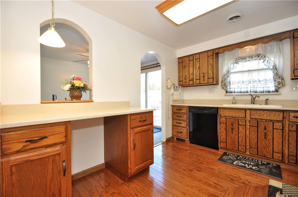 215 Bull Run Road Brownsville, PA 15417 - Photo 12 of 31 a kitchen with stainless steel appliances granite countertop a stove a sink and a wooden floors