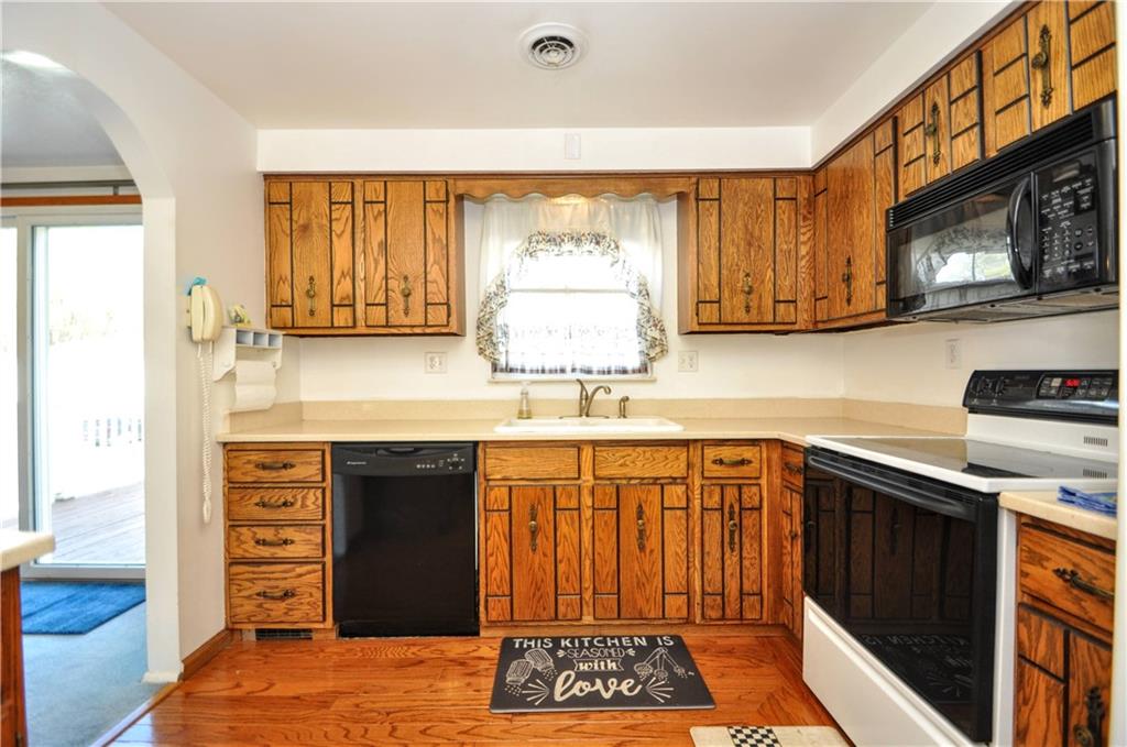 215 Bull Run Road Brownsville, PA 15417 - Photo 13 of 31 a kitchen with stainless steel appliances granite countertop a stove a sink and a microwave