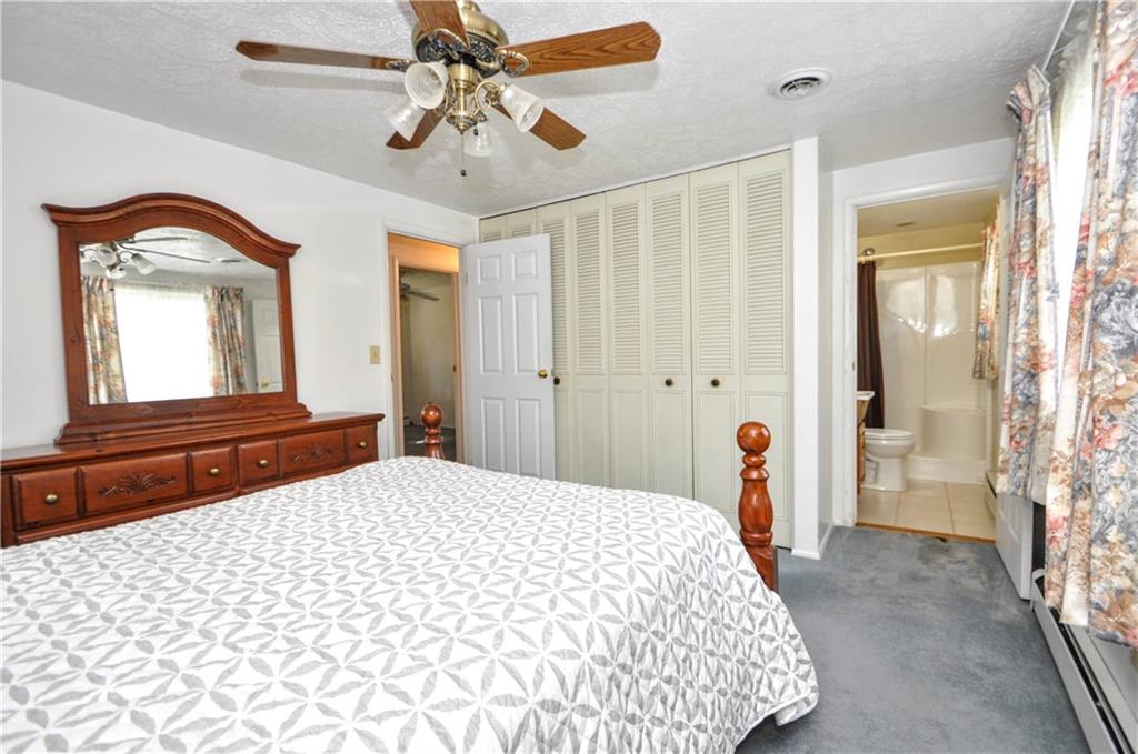 215 Bull Run Road Brownsville, PA 15417 - Photo 16 of 31 a bedroom with a large bed and a chandelier