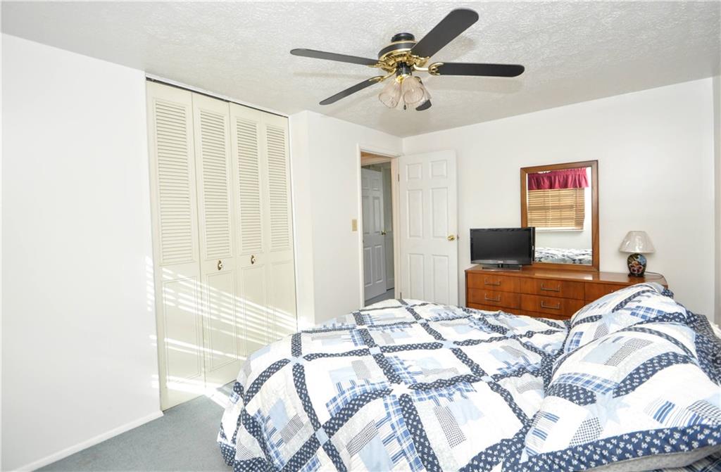 215 Bull Run Road Brownsville, PA 15417 - Photo 20 of 31 a bedroom with a large bed and a chandelier