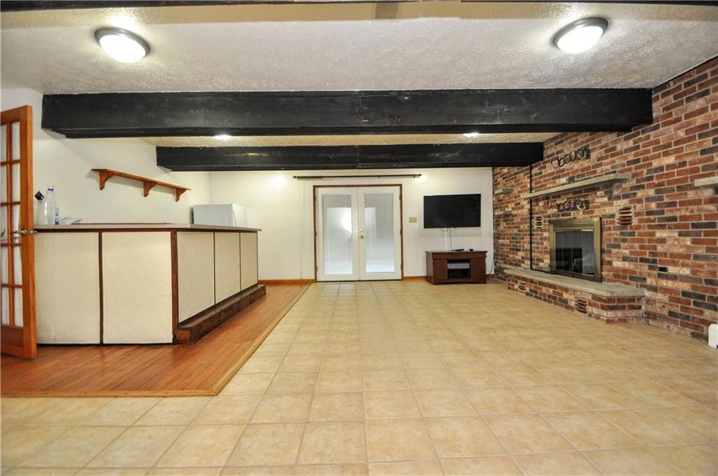 215 Bull Run Road Brownsville, PA 15417 - Photo 22 of 31 a view of an empty room with wooden floor and a fireplace