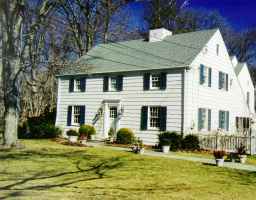 a view of a house with a yard porch and sitting area