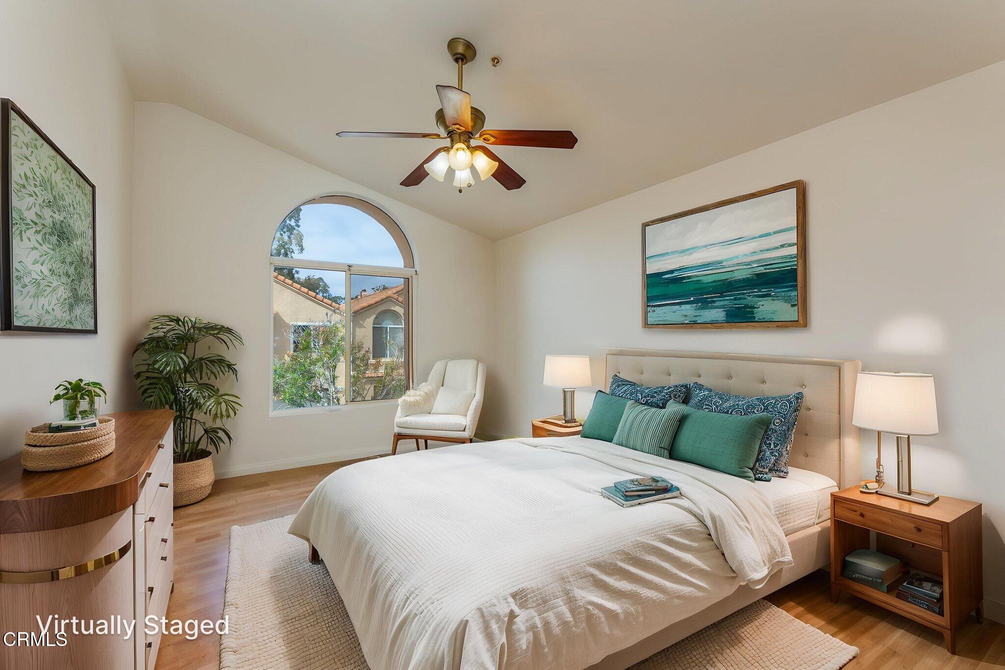 1132 Mooring Walk Oxnard, CA 93030 - Photo 11 of 30 a bedroom with a bed and a chandelier