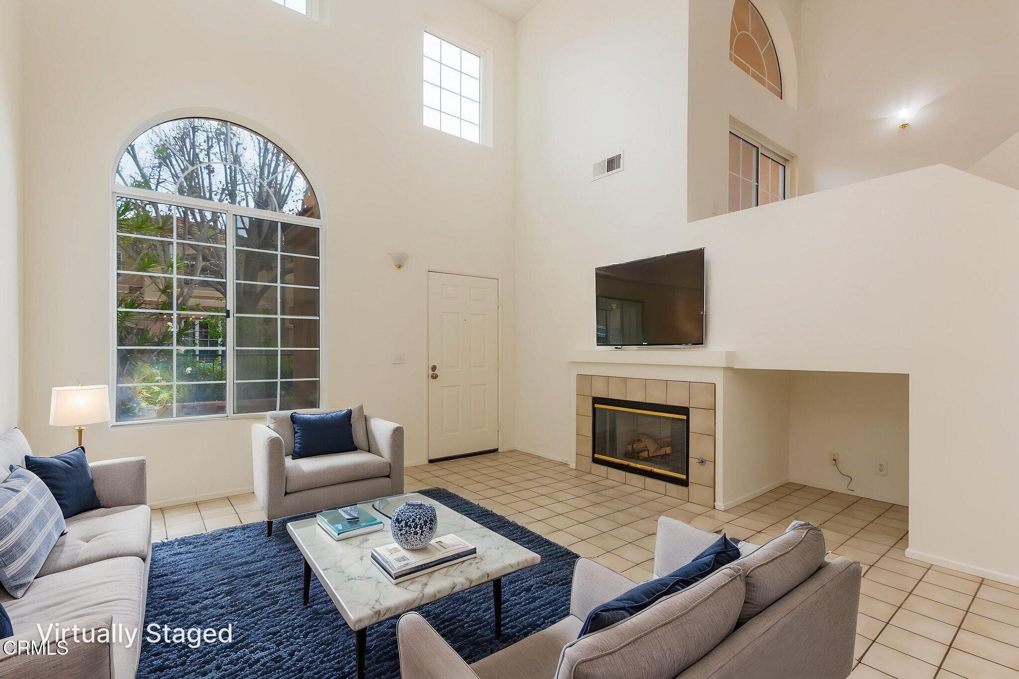 1132 Mooring Walk Oxnard, CA 93030 - Photo 2 of 30 a living room with furniture a flat screen tv and a fireplace