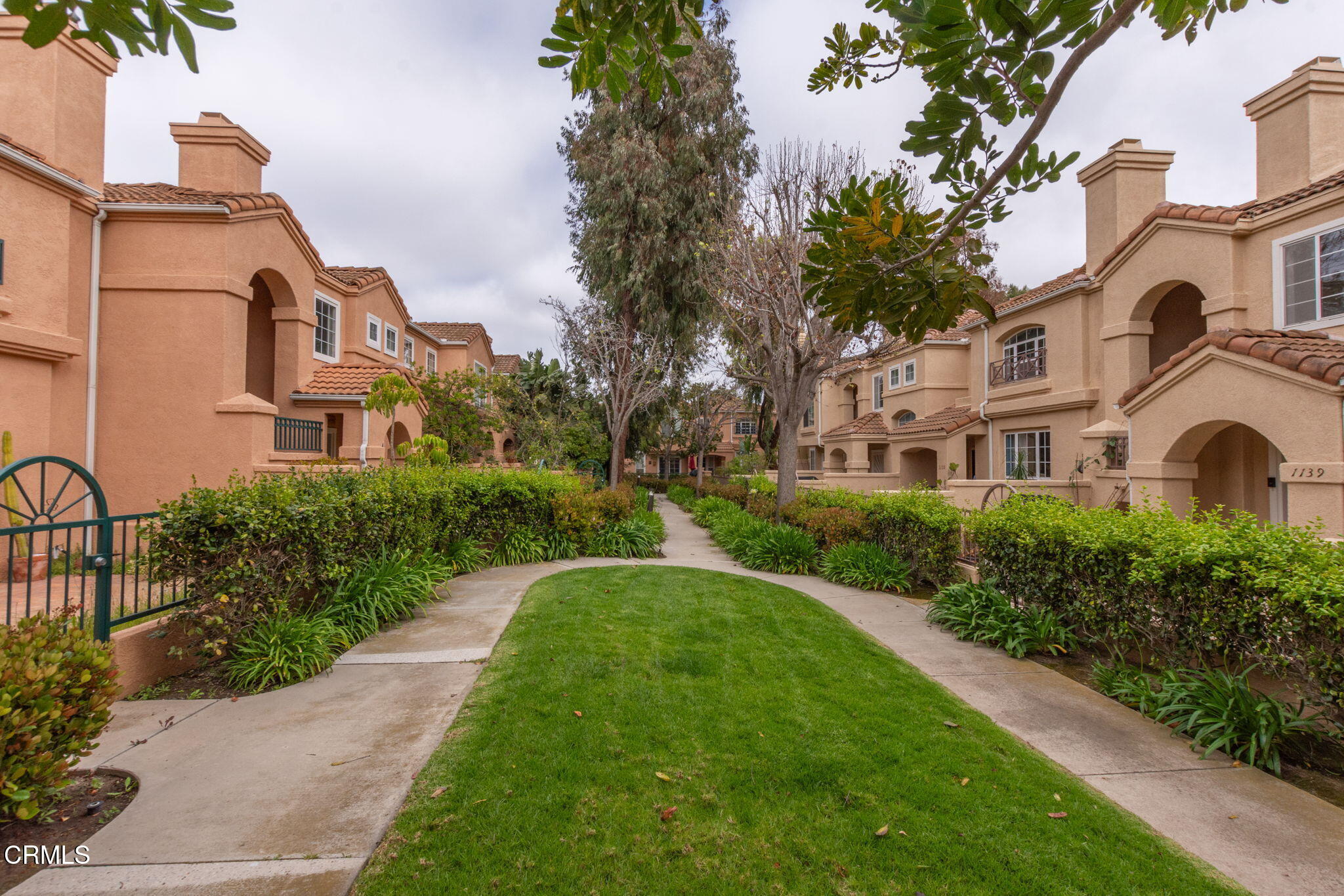 1132 Mooring Walk Oxnard, CA 93030 - Photo 22 of 30 a front view of a residential apartment building with a yard
