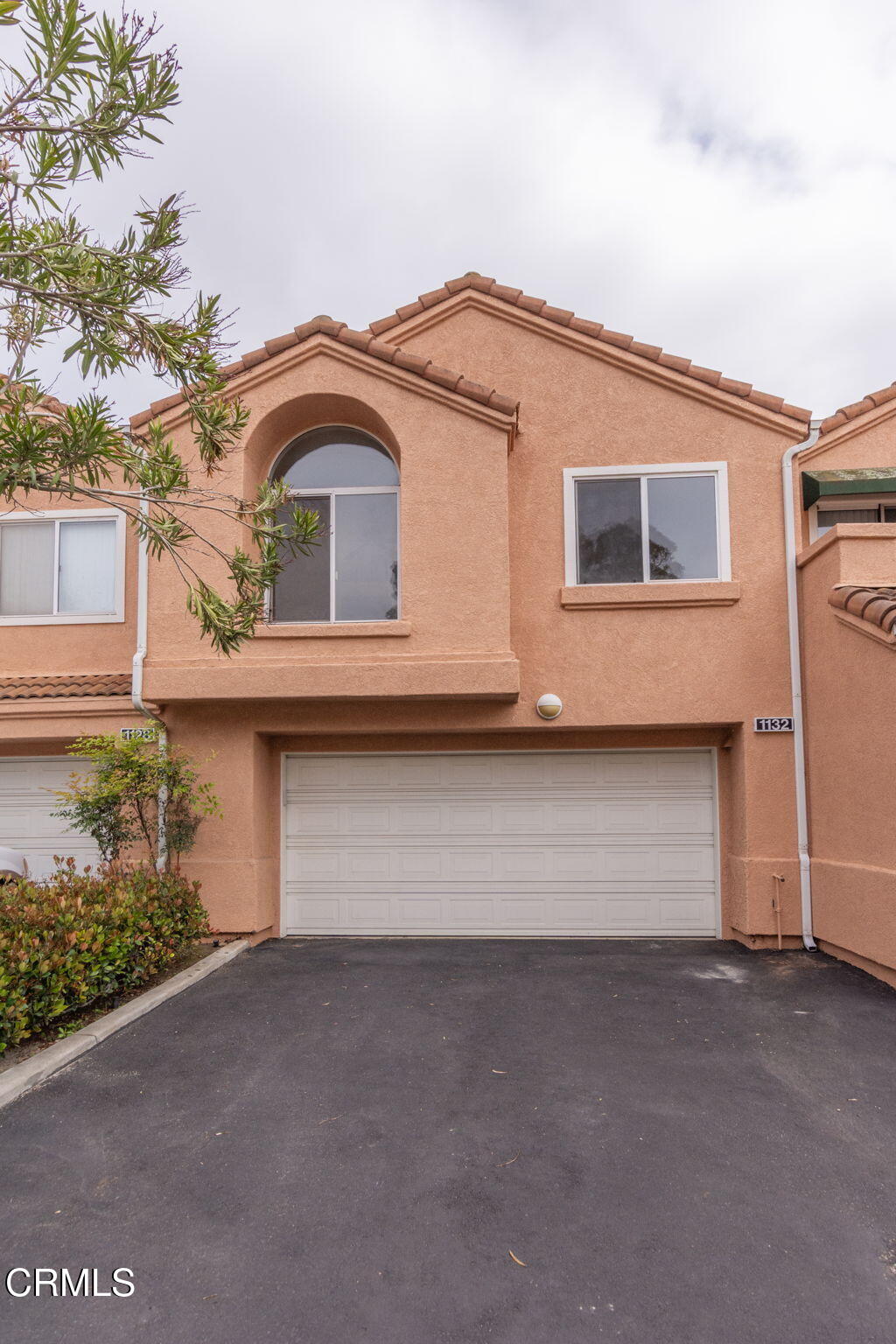1132 Mooring Walk Oxnard, CA 93030 - Photo 26 of 30 a front view of a house with a garage