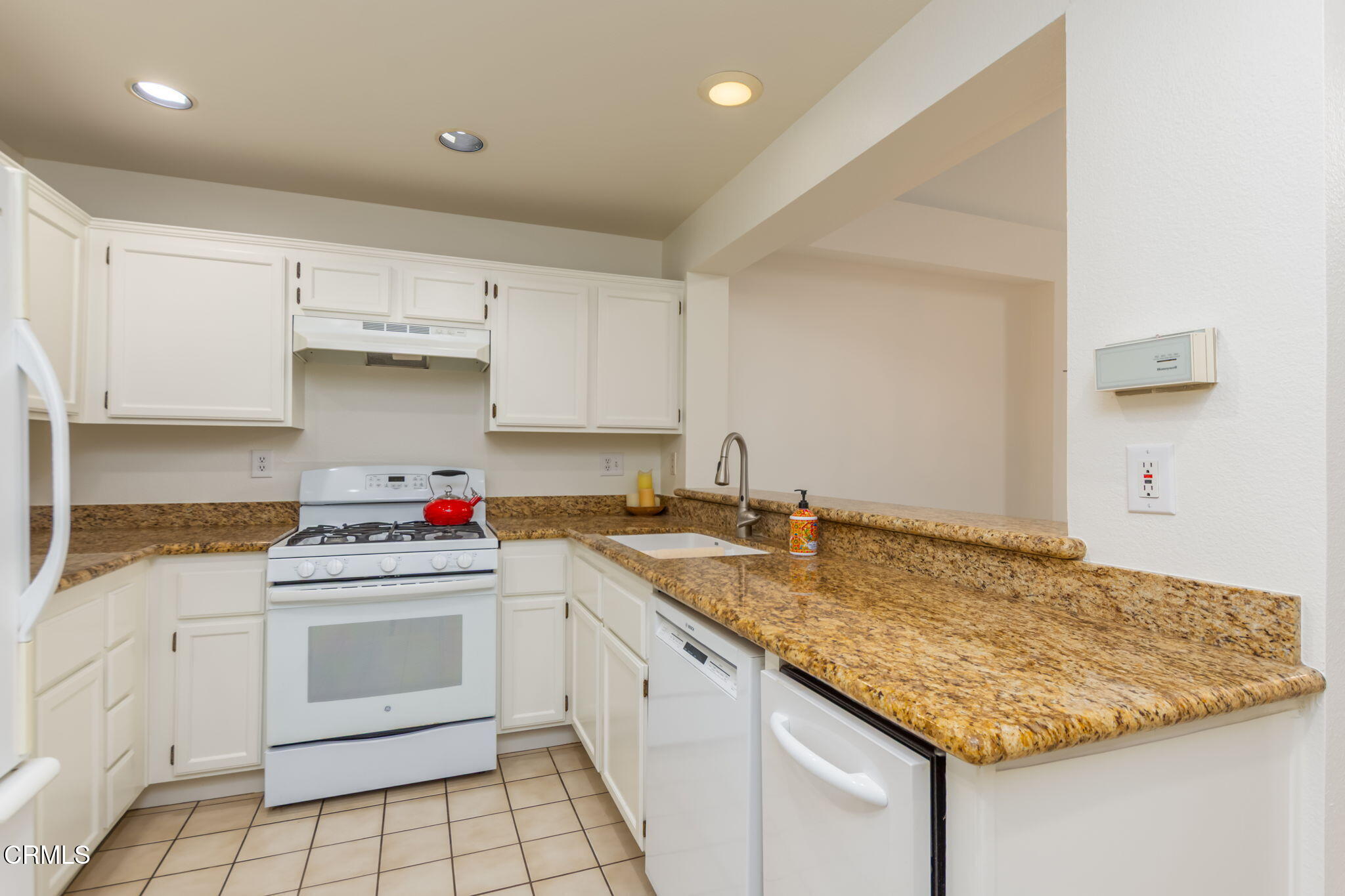 1132 Mooring Walk Oxnard, CA 93030 - Photo 7 of 30 a kitchen with a sink stove and cabinets
