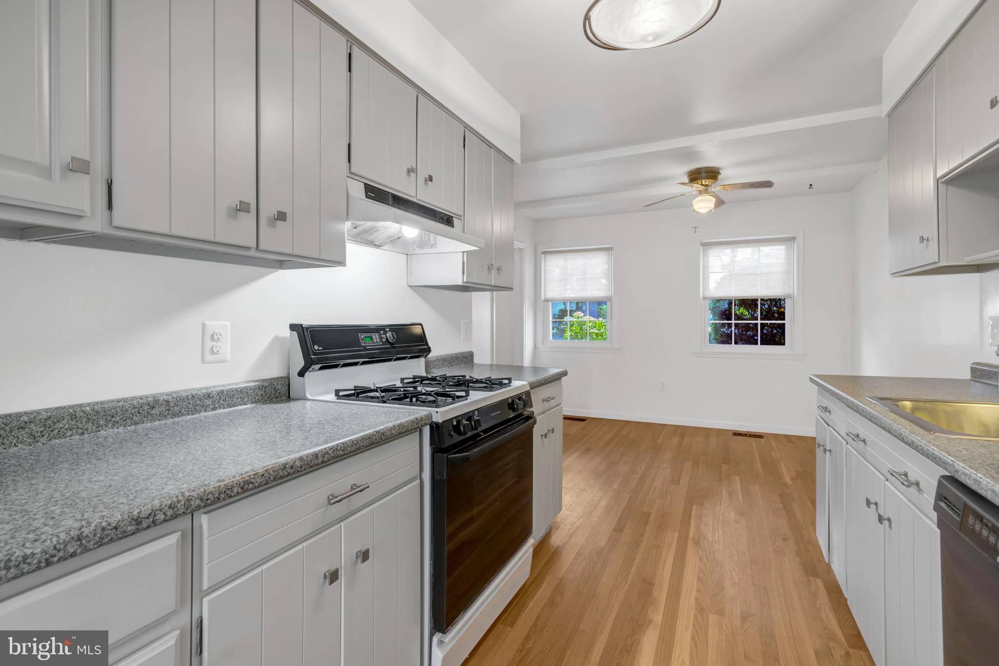 3221 Adams Court Fairfax, VA 22030 - Photo 10 of 51 a kitchen with granite countertop wooden cabinets and white appliances