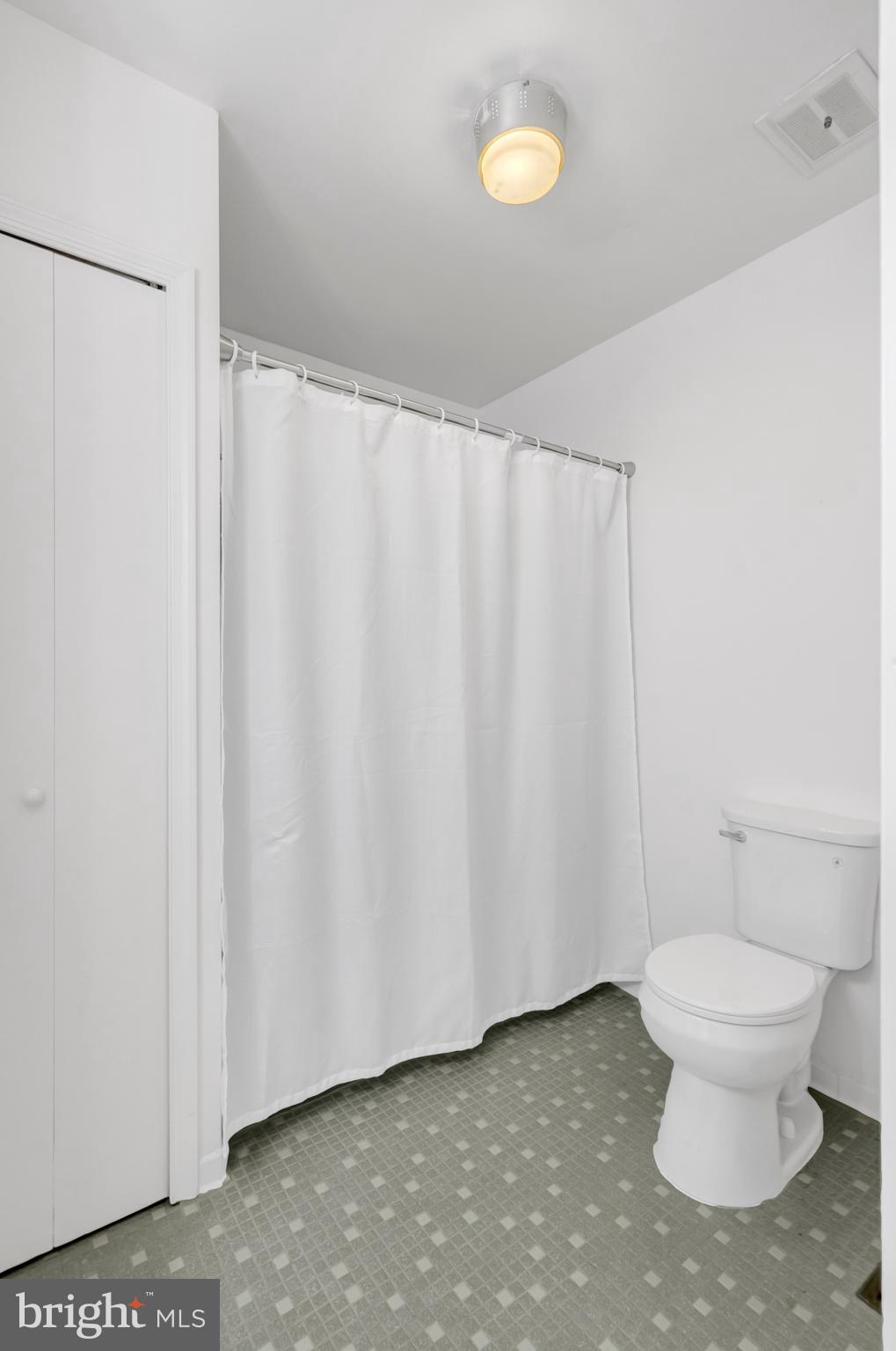 3221 Adams Court Fairfax, VA 22030 - Photo 25 of 51 a bathroom with a toilet and a shower curtain