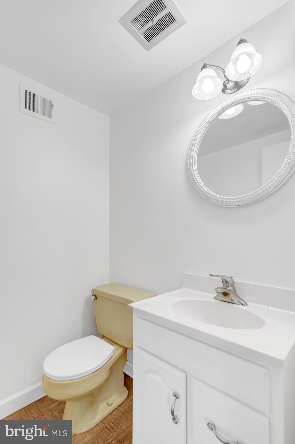 3221 Adams Court Fairfax, VA 22030 - Photo 36 of 51 a bathroom with a sink a toilet and a mirror