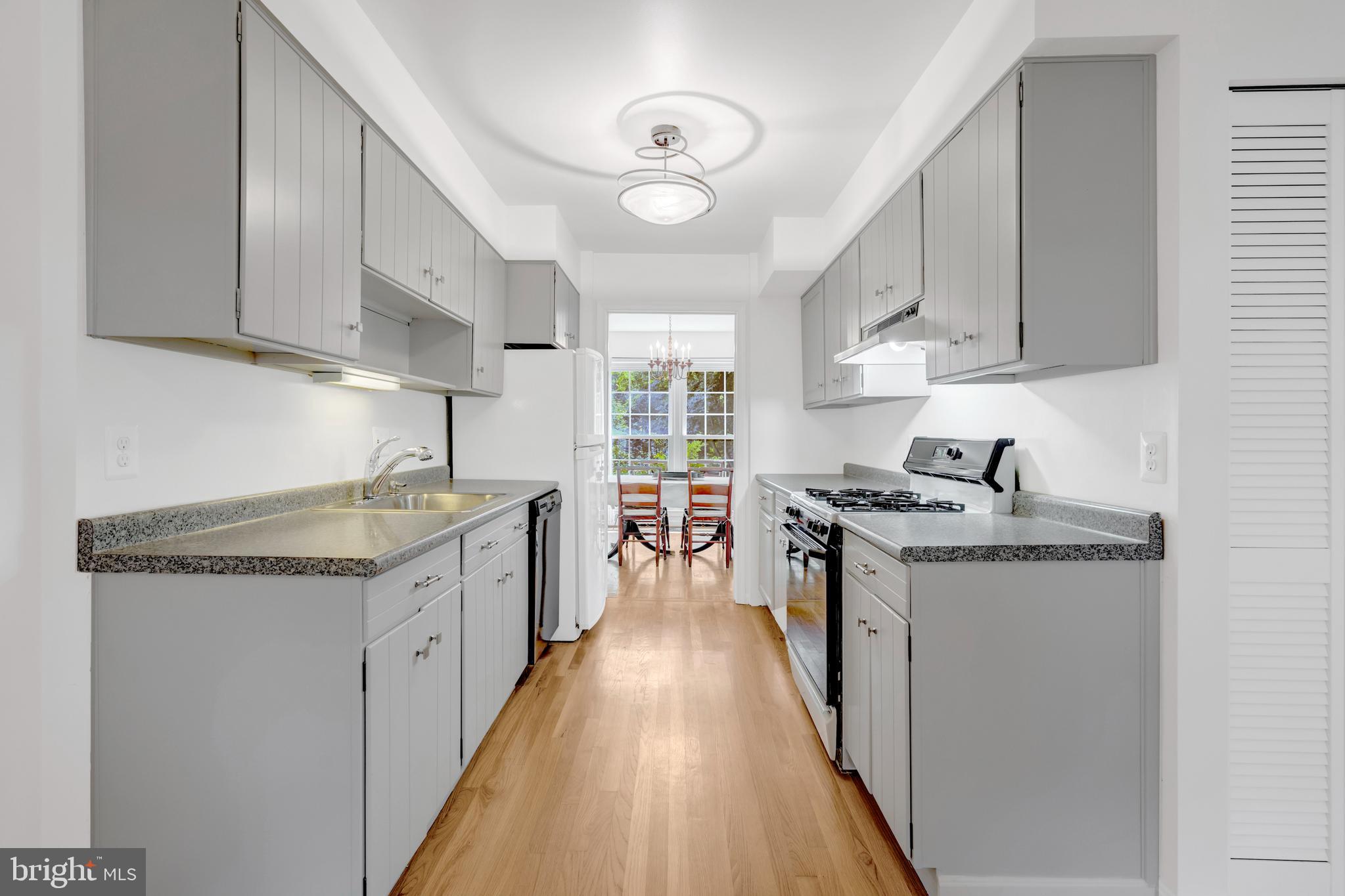 3221 Adams Court Fairfax, VA 22030 - Photo 9 of 51 a kitchen with granite countertop a sink stove and cabinets