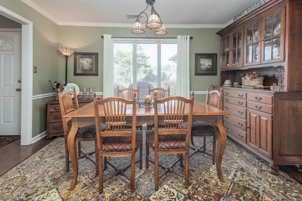 4600 Shadow Field Lane Bartlett, TN 38002 - Photo 13 of 33 a dining room with furniture a chandelier and wooden floor