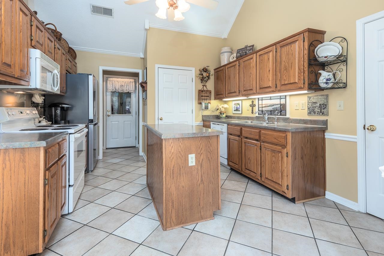 4600 Shadow Field Lane Bartlett, TN 38002 - Photo 14 of 33 a kitchen with stainless steel appliances granite countertop a stove a sink dishwasher and a refrigerator