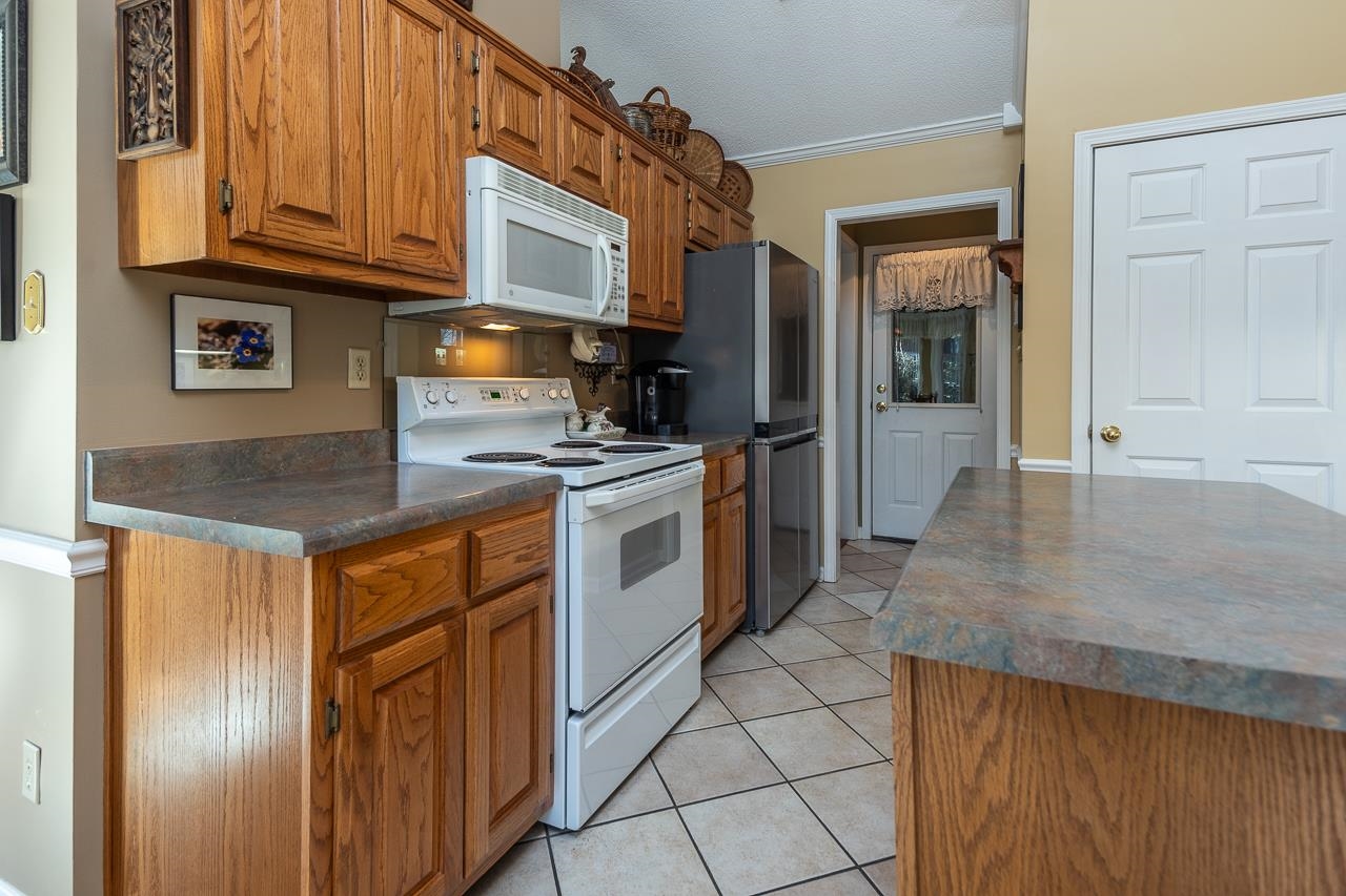 4600 Shadow Field Lane Bartlett, TN 38002 - Photo 16 of 33 a kitchen with stainless steel appliances granite countertop a stove a sink and a refrigerator