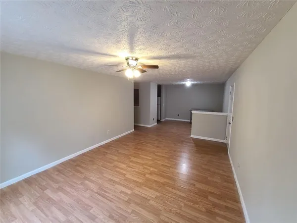 a view of an empty room with a chandelier