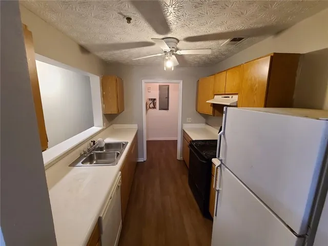 a view of living room with furniture and a ceiling fan