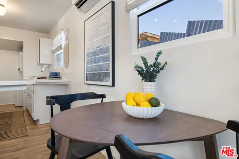 a view of a dining room with a table and chairs