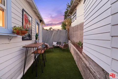 a backyard of a house with table and chairs