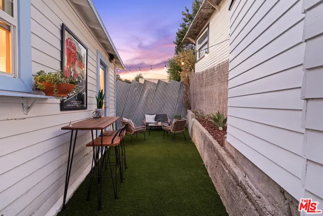 a backyard of a house with table and chairs