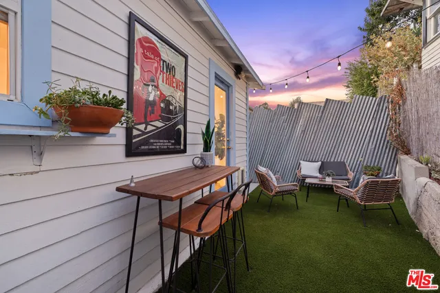 a backyard of a house with table and chairs