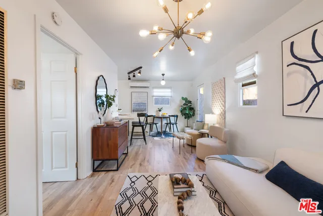a living room with furniture and a chandelier