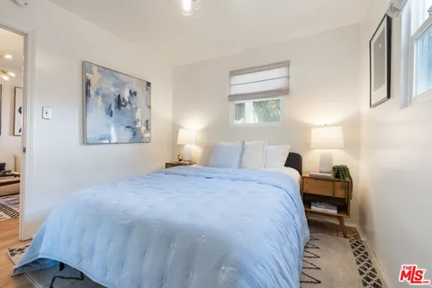 a bedroom with a bed and a lamp