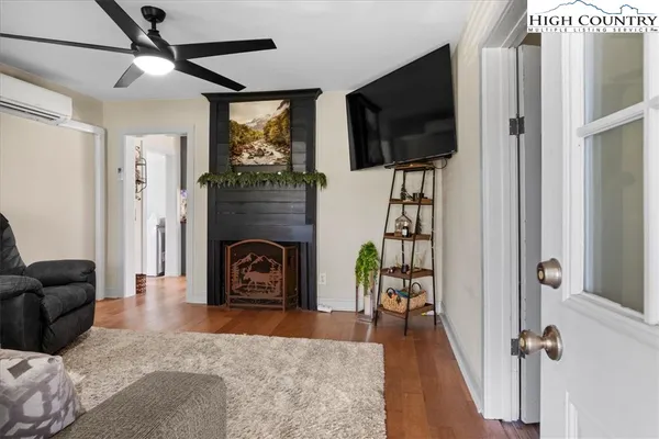 a living room with furniture flat screen tv and a fireplace