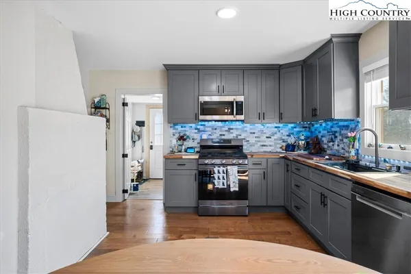 a kitchen with a refrigerator a stove top oven a sink and dishwasher