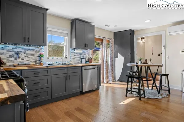 a kitchen with sink cabinets and wooden floor