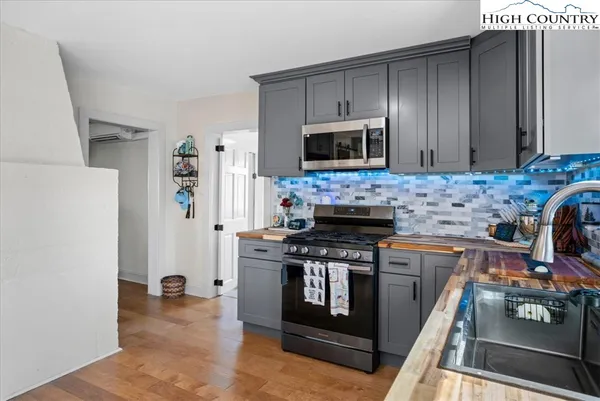 a kitchen with stainless steel appliances a stove a microwave and refrigerator