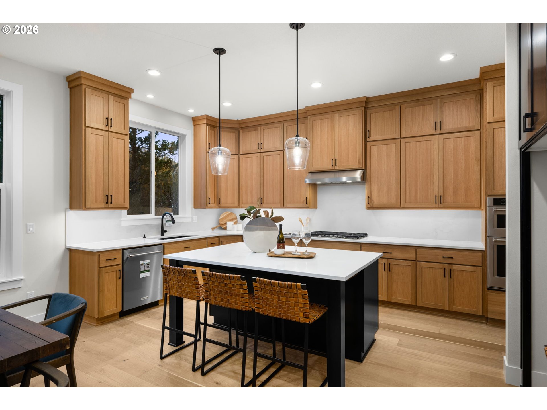 17669 Northwest Layla Drive, Unit LOT 4 Portland, OR 97229 - Photo 29 of 34 a kitchen with a sink dining table and chairs