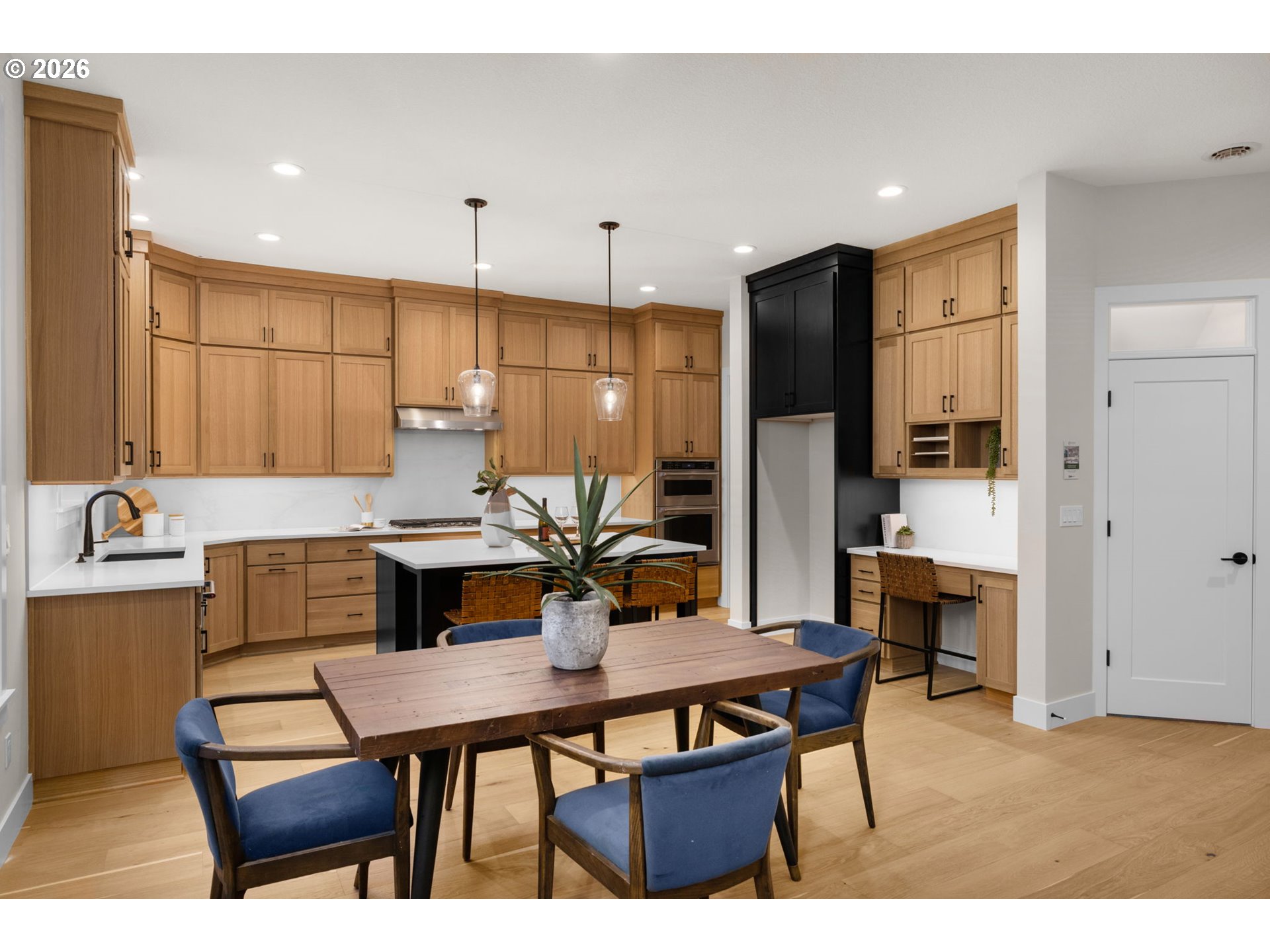 17669 Northwest Layla Drive, Unit LOT 4 Portland, OR 97229 - Photo 30 of 34 a kitchen with a table chairs refrigerator and microwave