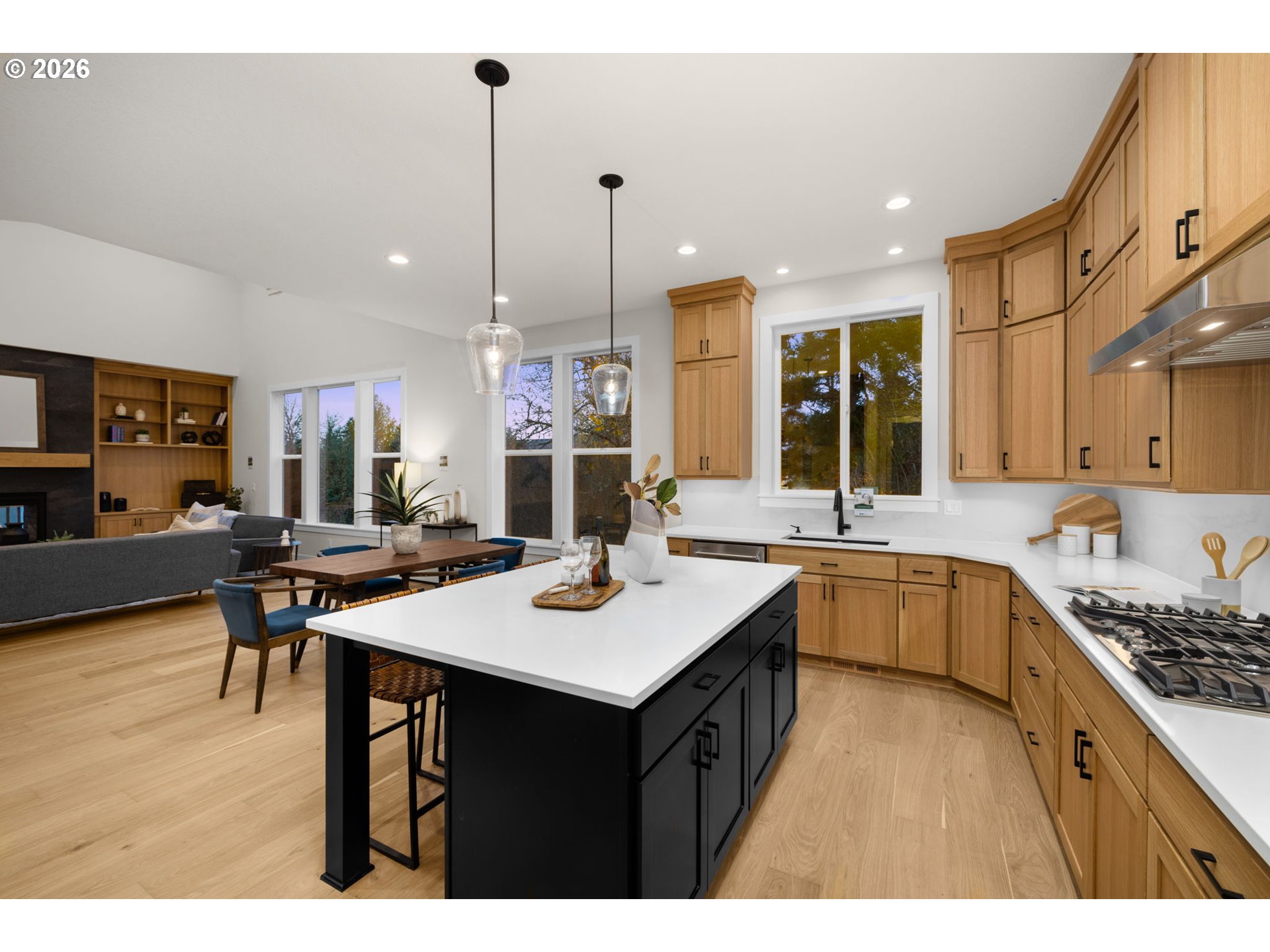 17669 Northwest Layla Drive, Unit LOT 4 Portland, OR 97229 - Photo 33 of 34 a kitchen with stainless steel appliances kitchen island granite countertop a table chairs sink and cabinets