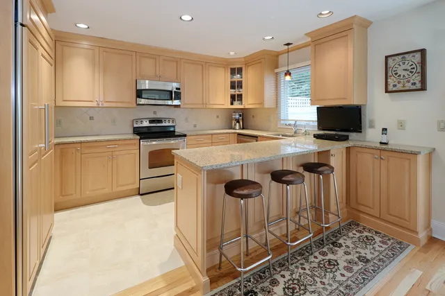 a kitchen with a stove a sink and a refrigerator