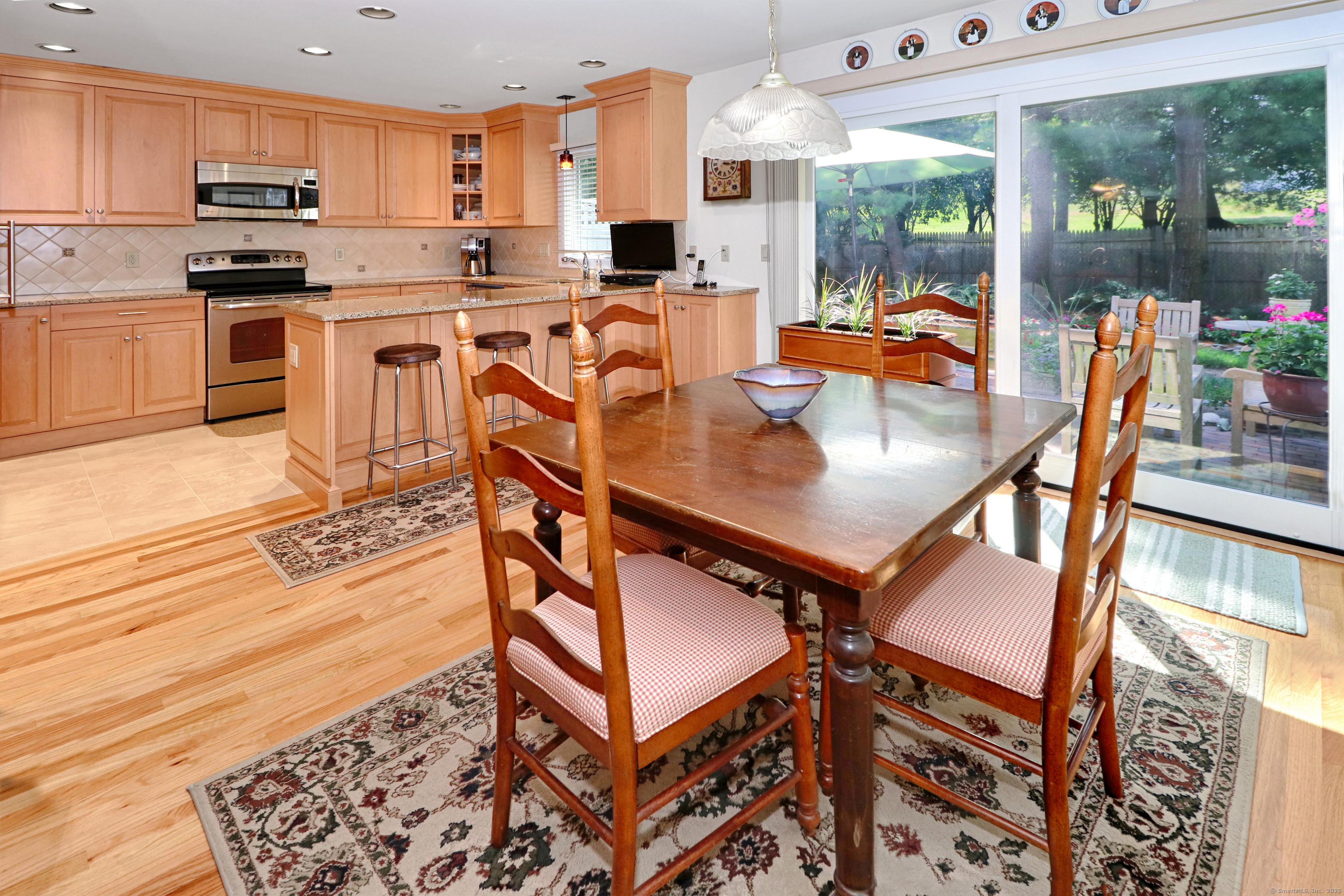 972 South Pine Creek Road, Unit 972 Fairfield, CT 06824 - Photo 15 of 37 a open kitchen with stainless steel appliances granite countertop a stove and a view of living room