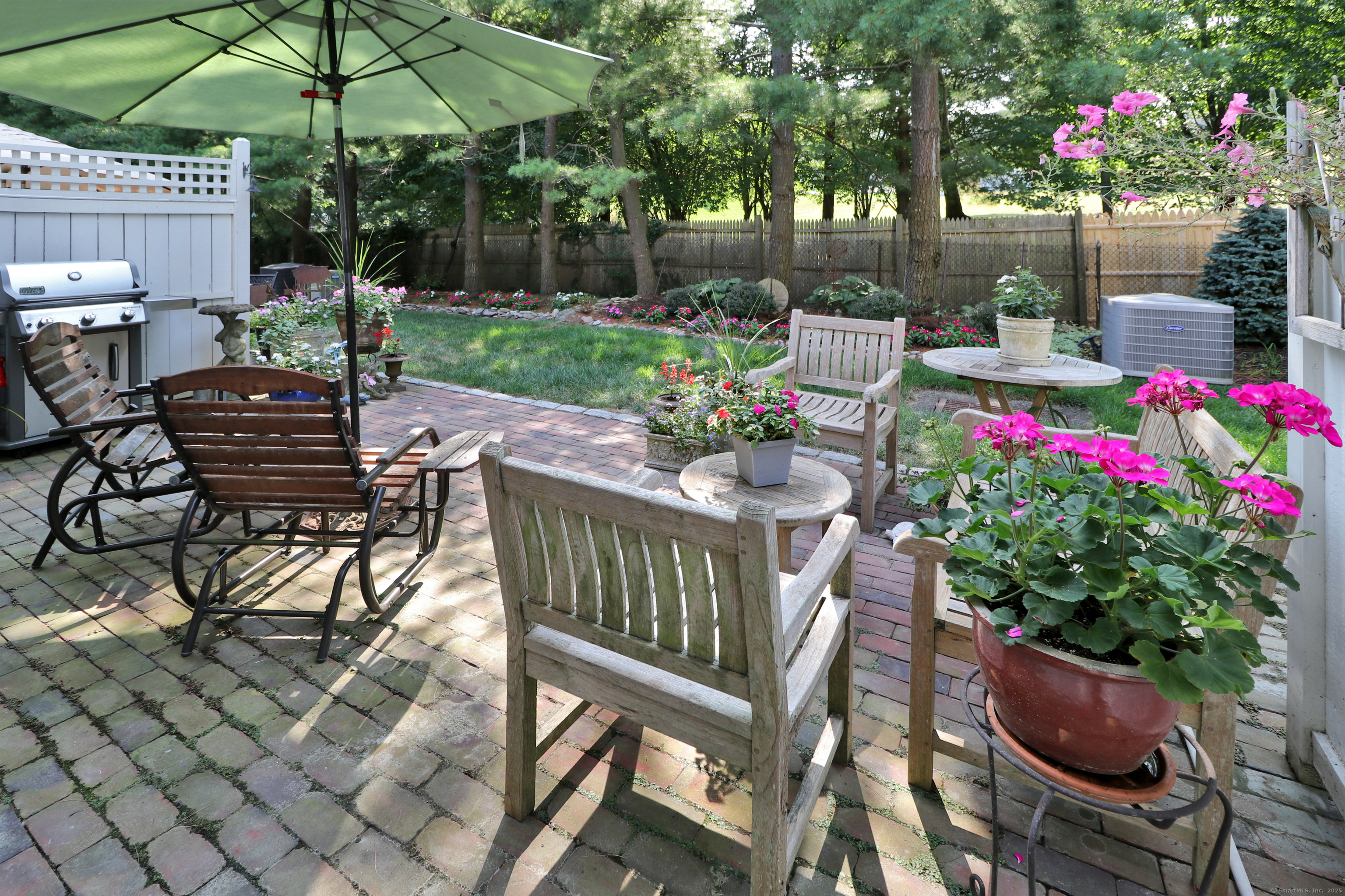 972 South Pine Creek Road, Unit 972 Fairfield, CT 06824 - Photo 16 of 37 a view of a chairs and table in backyard of the house