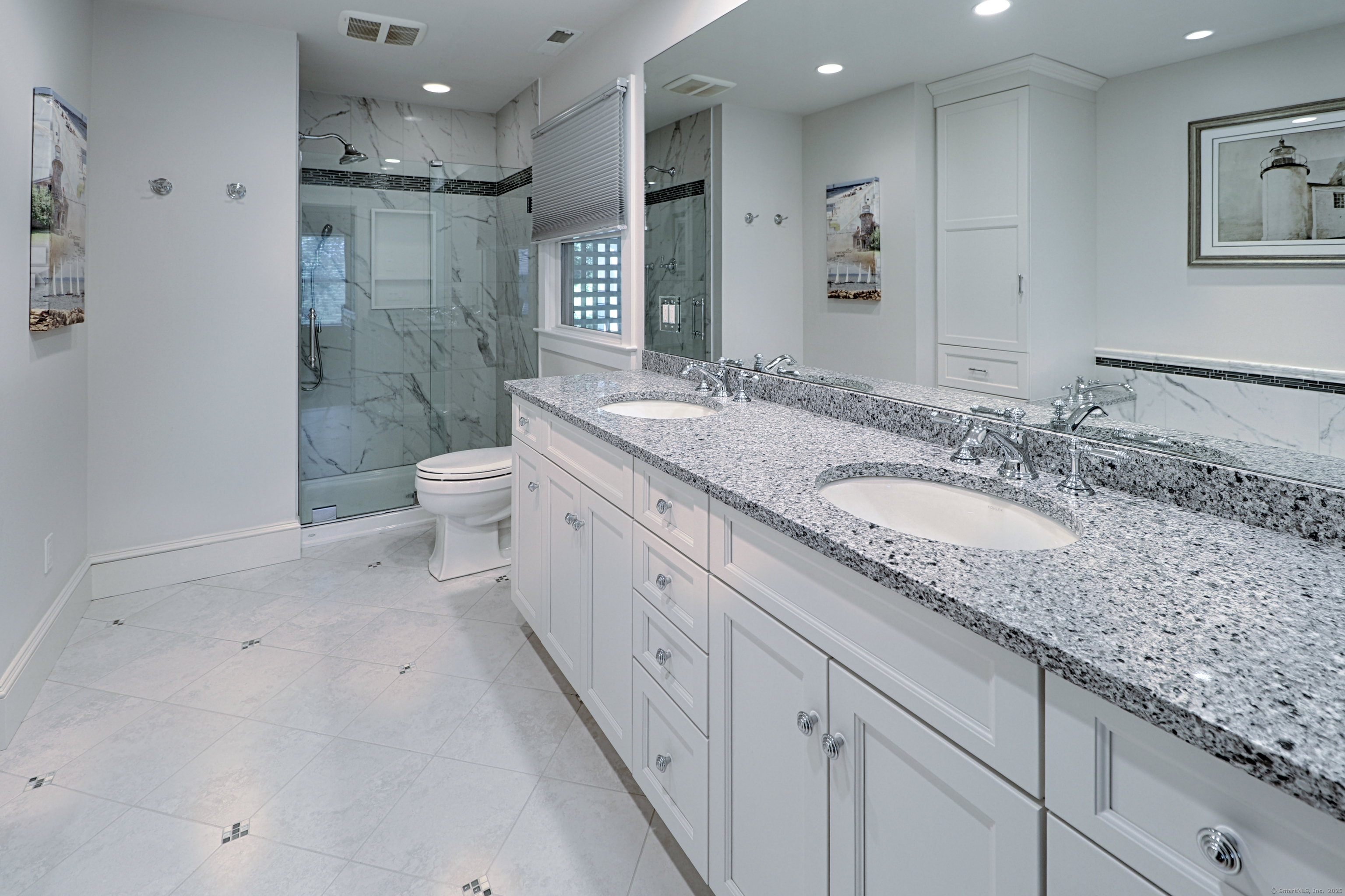 972 South Pine Creek Road, Unit 972 Fairfield, CT 06824 - Photo 21 of 37 a spacious bathroom with a granite countertop sink a toilet a mirror and shower
