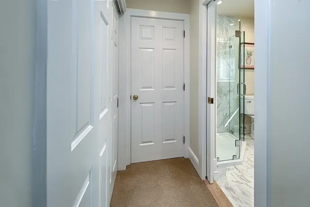 a bathroom with a granite countertop toilet a sink and a shower