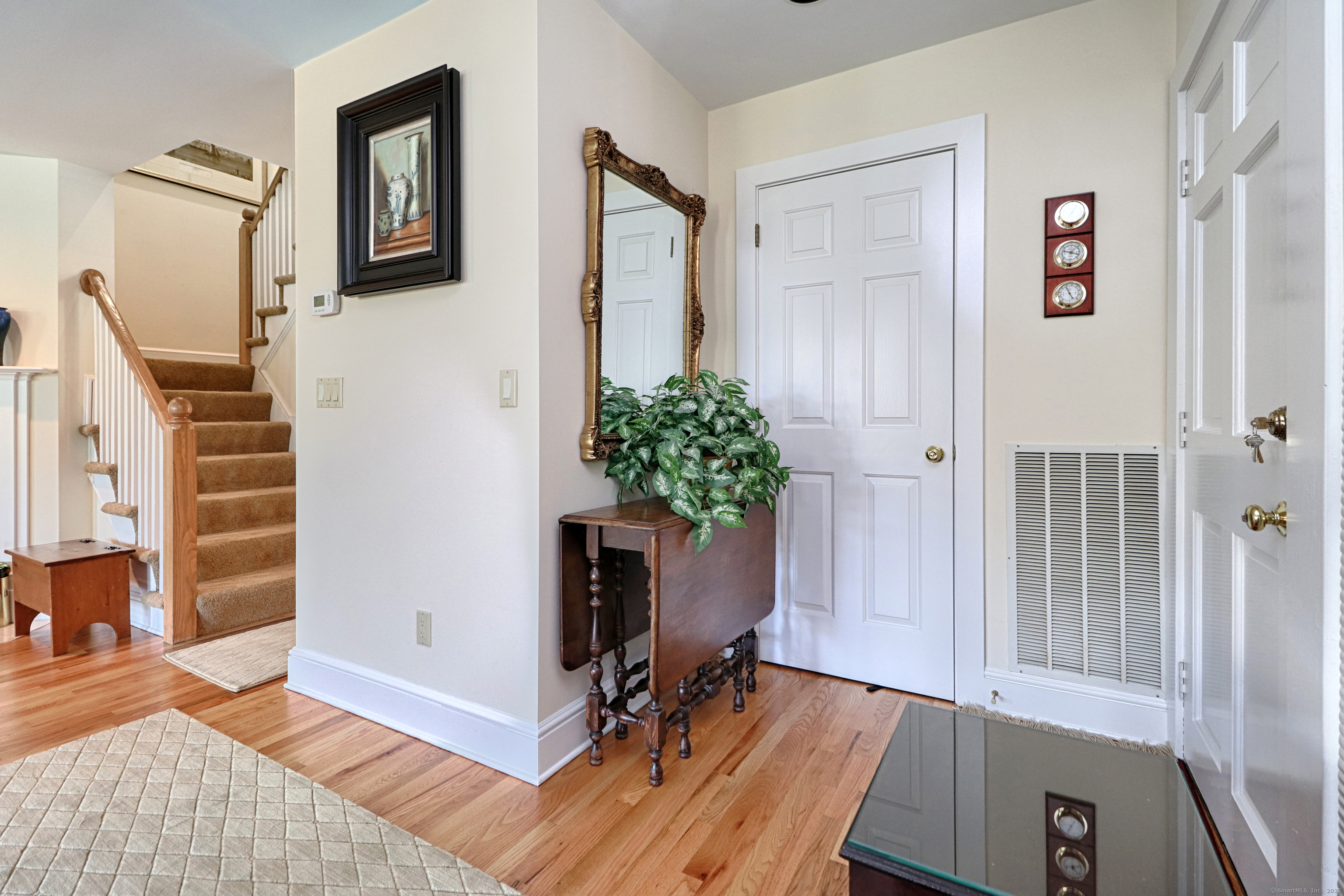 972 South Pine Creek Road, Unit 972 Fairfield, CT 06824 - Photo 4 of 37 a workspace with furniture and a potted plant