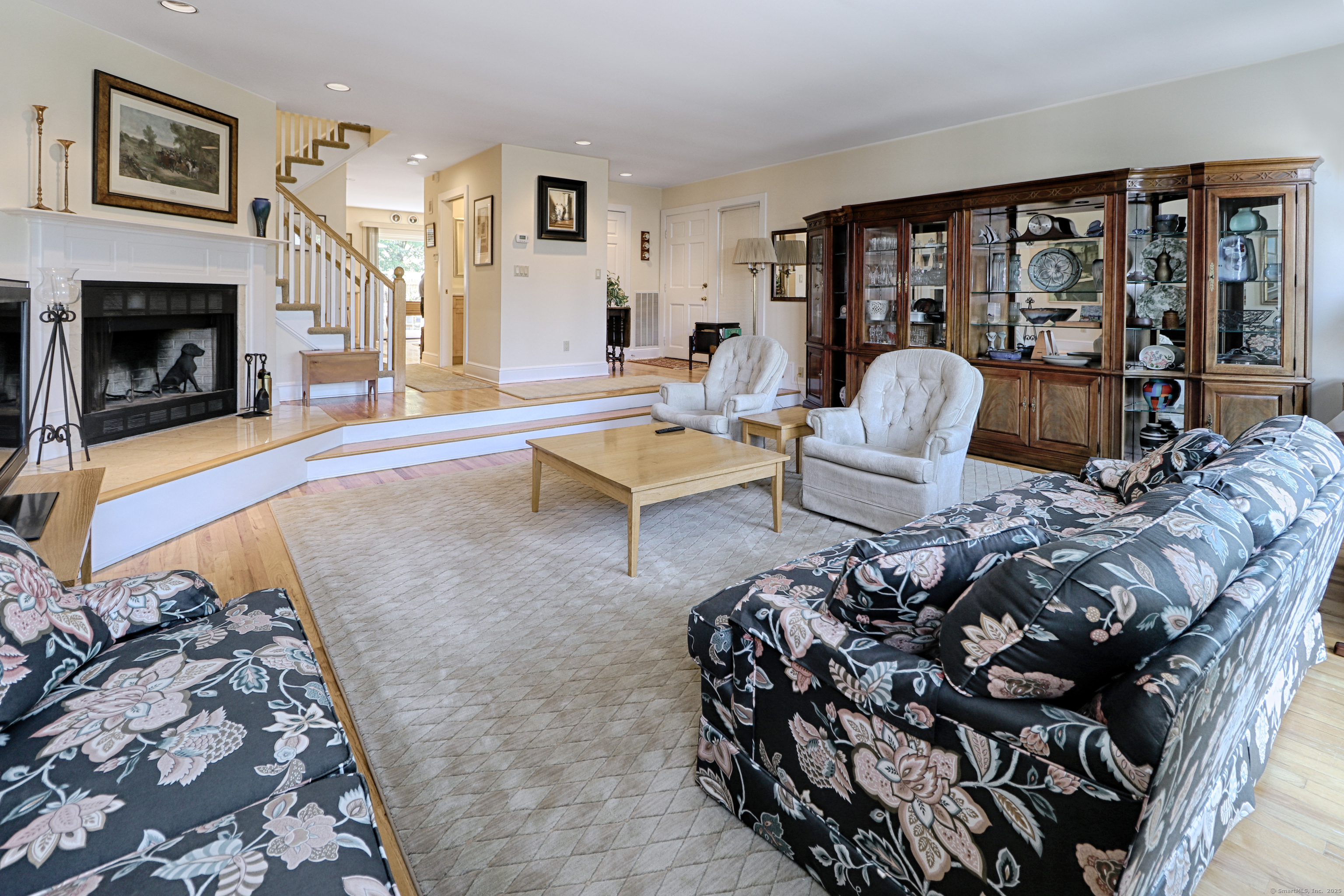 972 South Pine Creek Road, Unit 972 Fairfield, CT 06824 - Photo 8 of 37 a living room with furniture large window and a fireplace