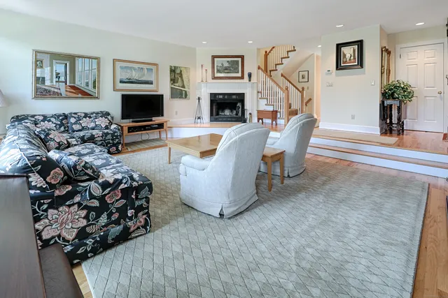 a living room with furniture large window and fireplace