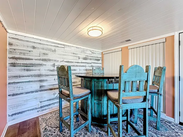 a bedroom with a bed and a large mirror on the dresser