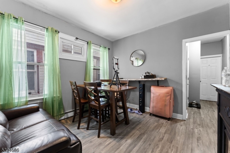 907 Flora Street Elizabeth, NJ 07201 - Photo 13 of 24 a view of a dining room with furniture window and wooden floor