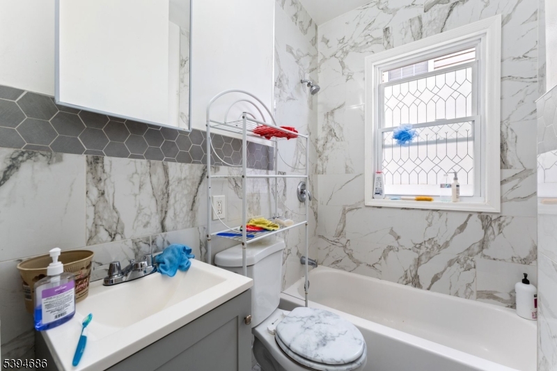 907 Flora Street Elizabeth, NJ 07201 - Photo 16 of 24 a bathroom with a sink toilet tub and shower