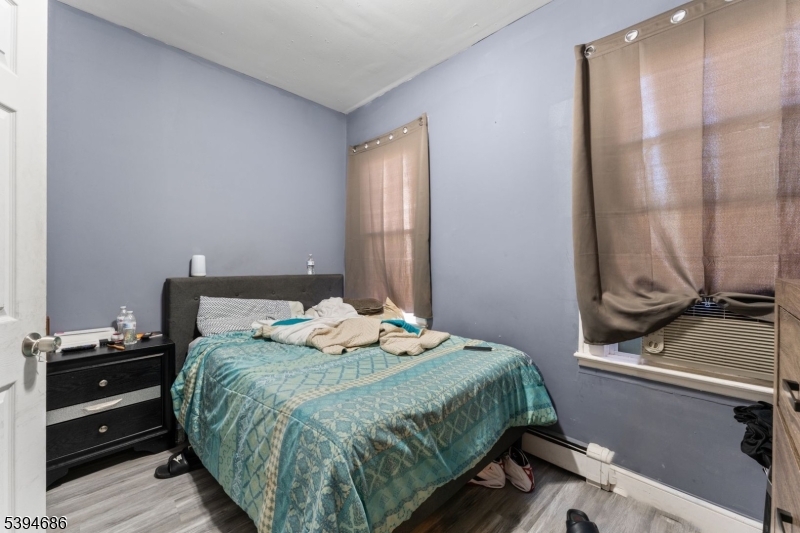 907 Flora Street Elizabeth, NJ 07201 - Photo 17 of 24 a bedroom with a bed and a window