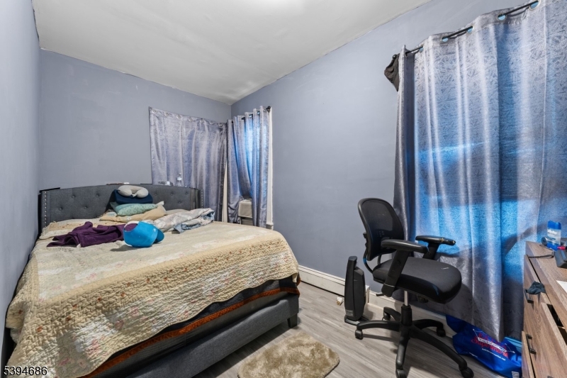 907 Flora Street Elizabeth, NJ 07201 - Photo 18 of 24 a bedroom with a bed and a window