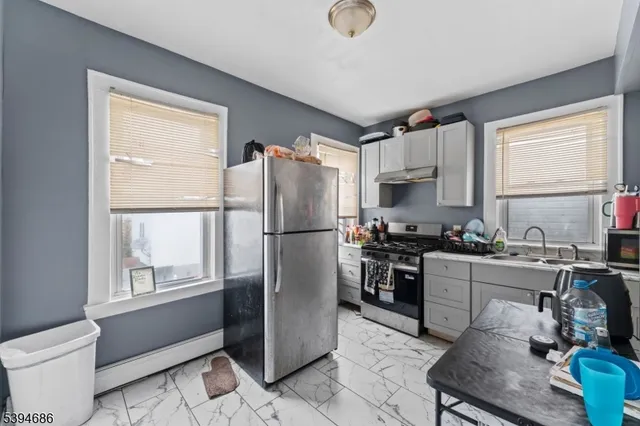 a kitchen with a sink cabinets and window