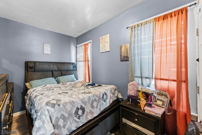 907 Flora Street Elizabeth, NJ 07201 - Photo 9 of 24 a bedroom with a bed and a window