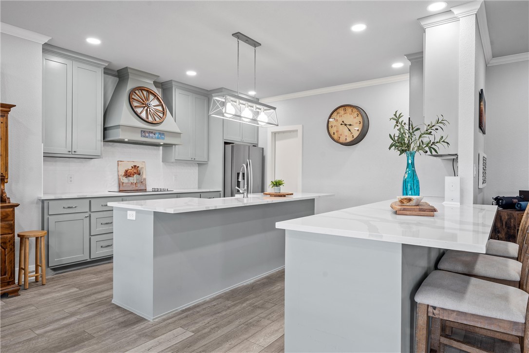 1227 Alexander Road Moody, TX 76557 - Photo 12 of 66 a kitchen with a table and a clock on the wall